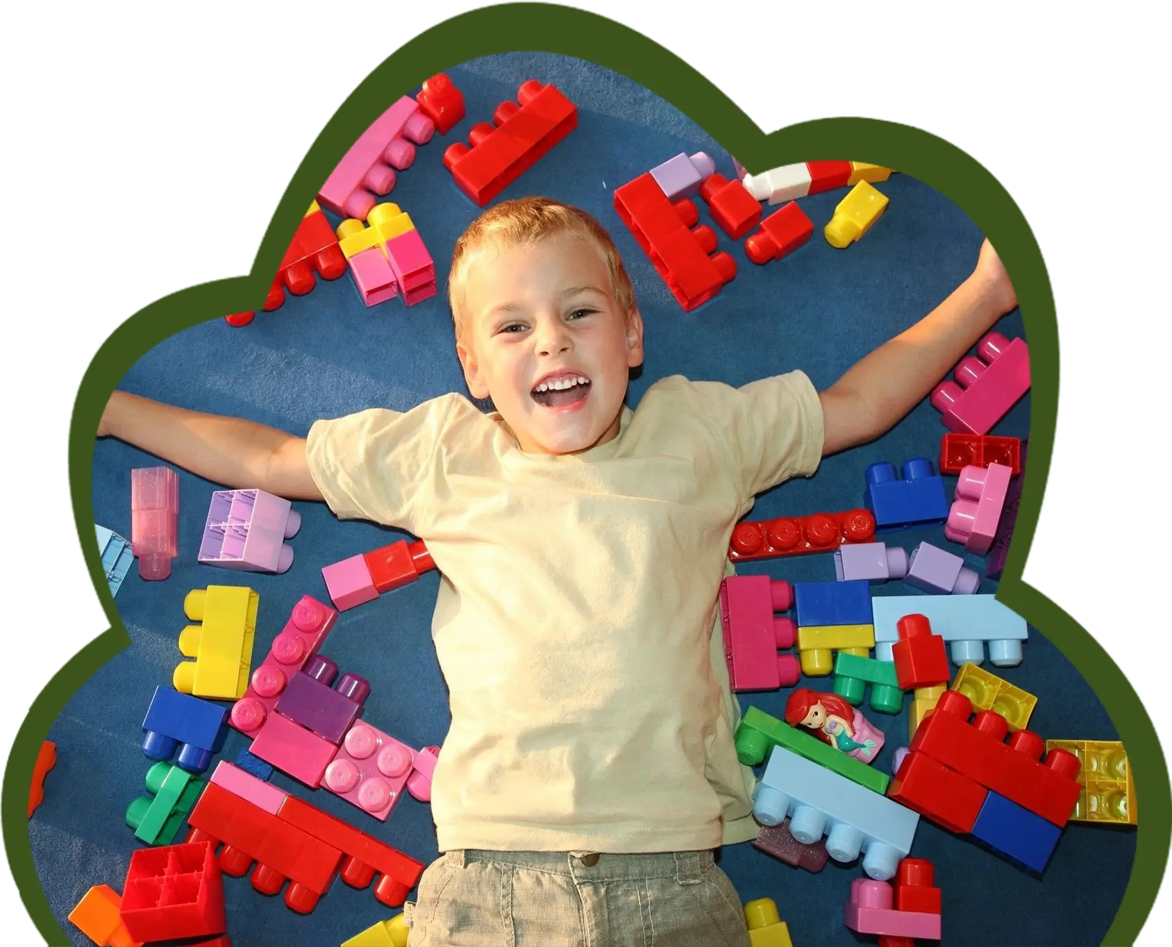 a boy laying among building blocks
